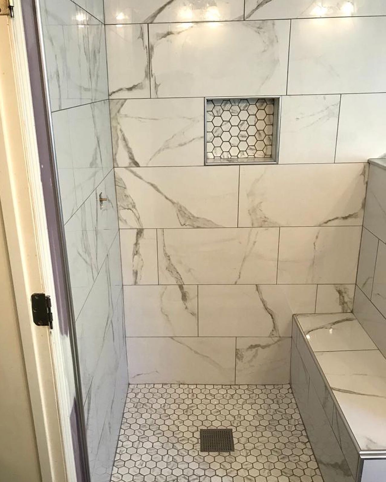 Tile shower with hex mosaics for the niche and the floor