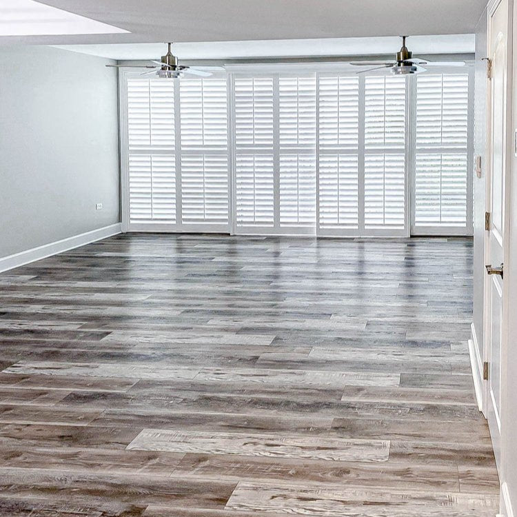 Empty room with wooden flooring and white walls