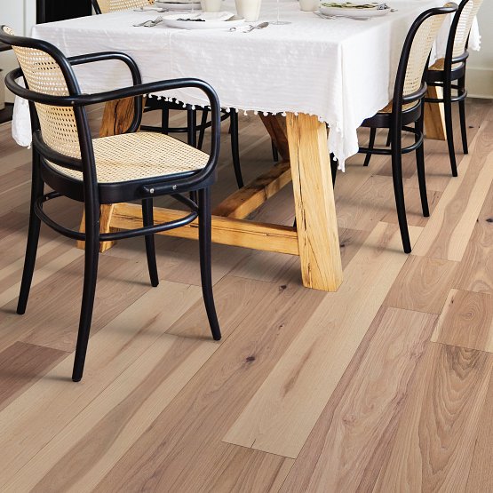 This is a room scene of imperial pecan in the color linen. This is a dining room with black chairs and alight wood table
