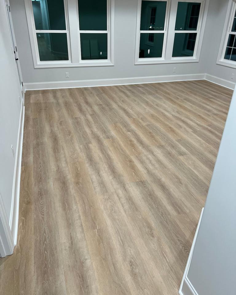 Bedroom with a light colored lvp