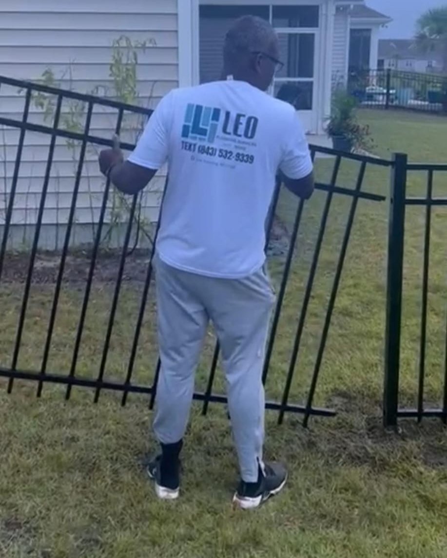 man installing fence