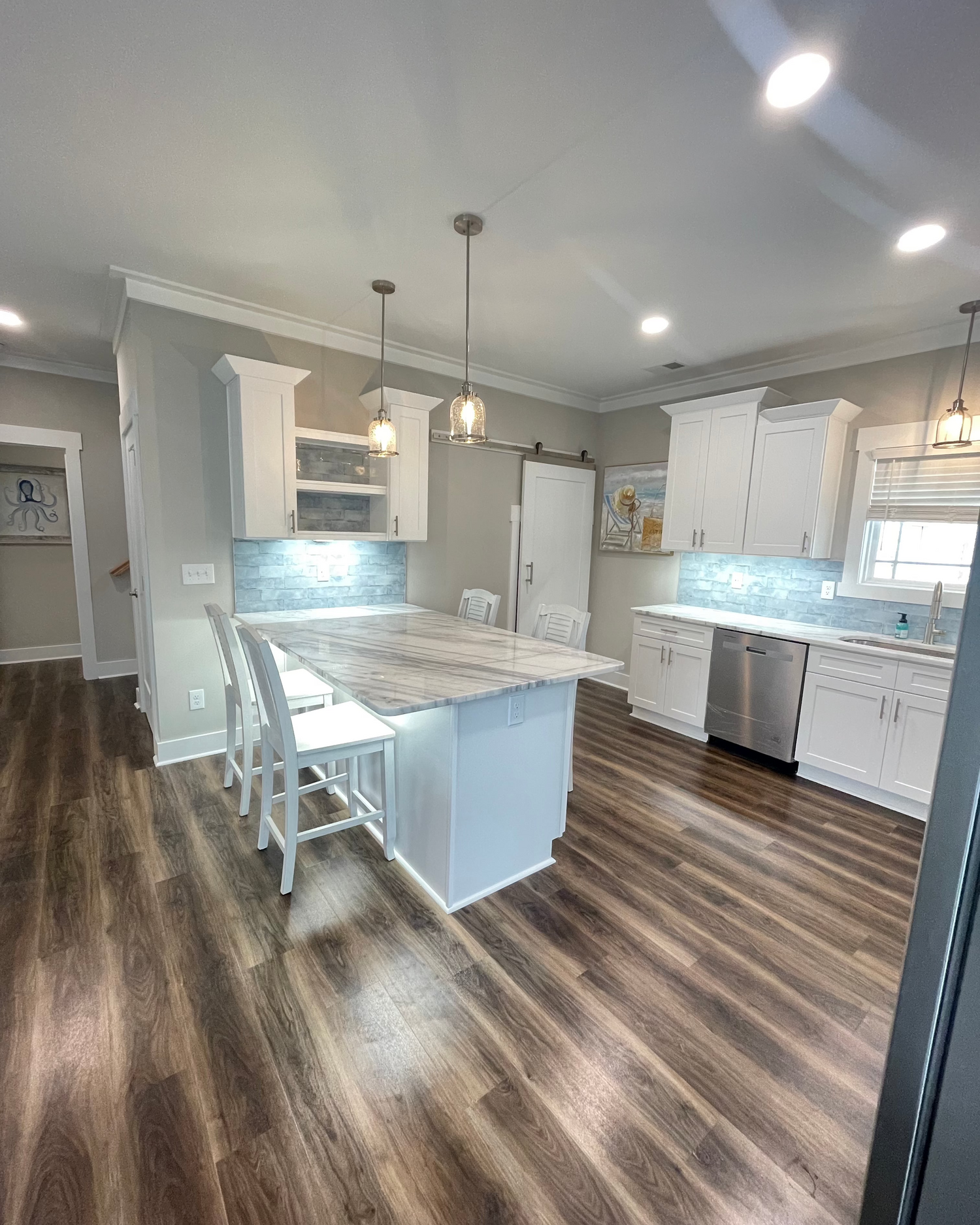 A kitchen image with new flooring and backsplash