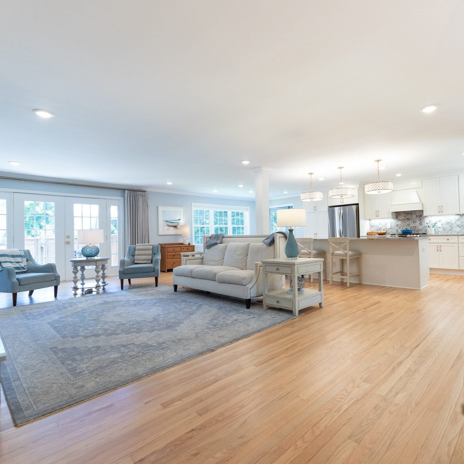 A living room Scene with a blue carpet and beachy feel