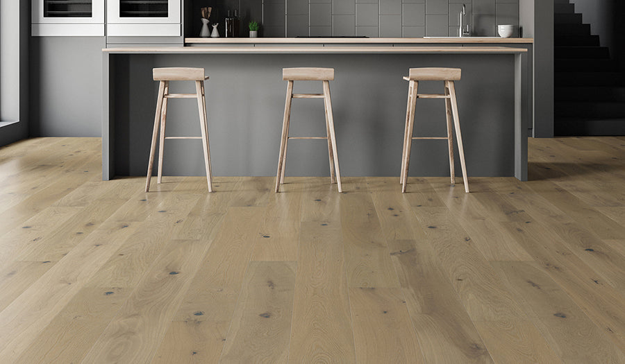 This is a room scene of a ktichen with dark gray cabinets and hardwood flooring palladio in the color driftwood