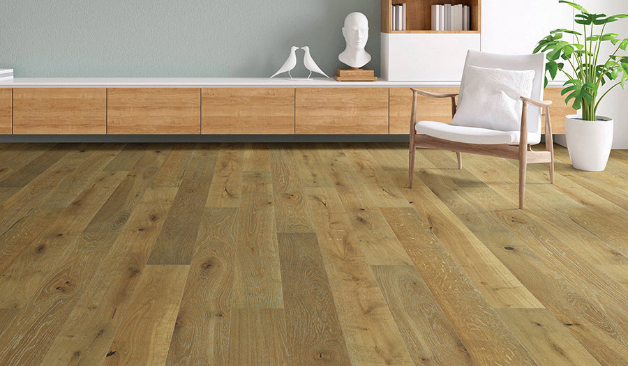 This is a room scene of the hardwood floor palladio in the color nantucket. There is white furniture and marble decor