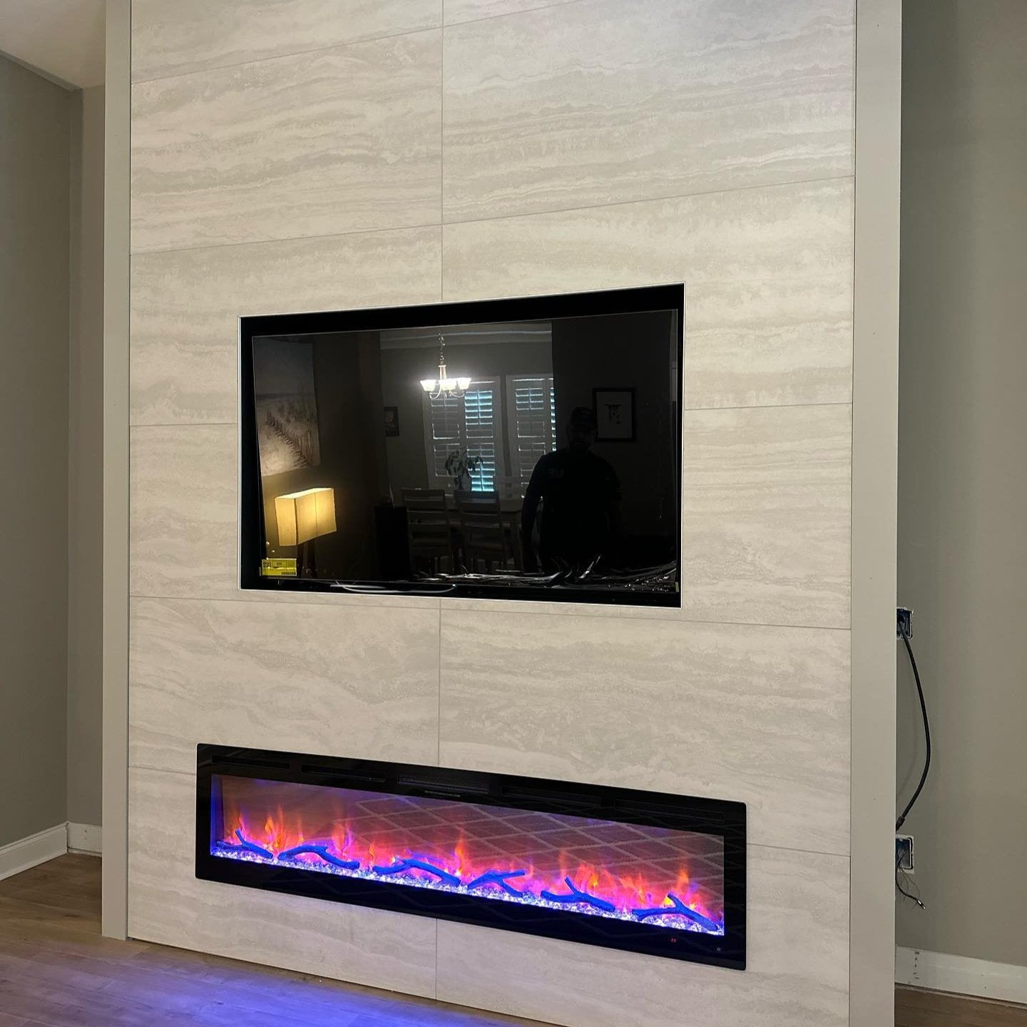 a fireplace with large format tiles