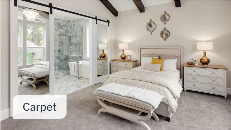 This is a picture of a bedroom with carpet flooring and white night stands