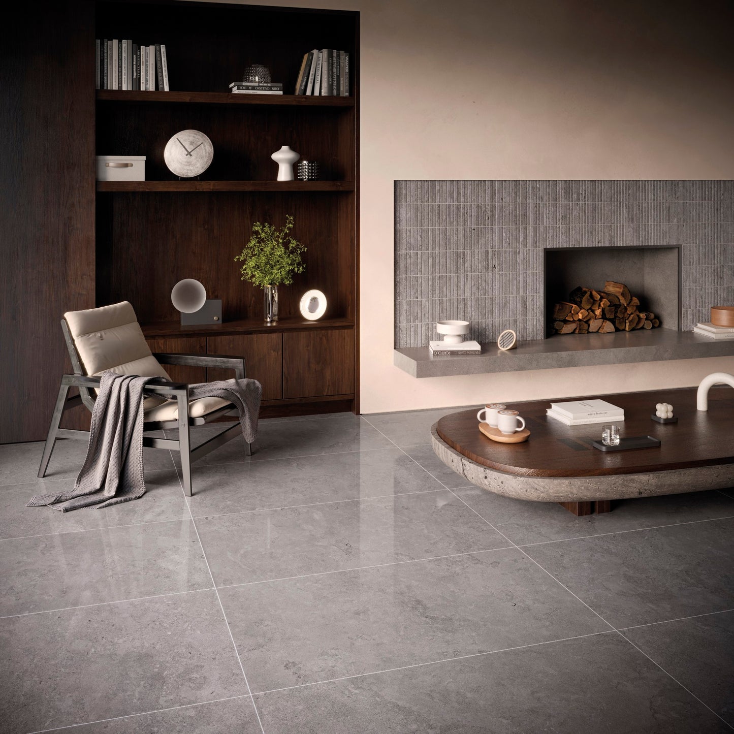 This is a living room display of the tile norian in the color ash. There is a wooden/marble coffe table with a cream chair and espresso bookcase
