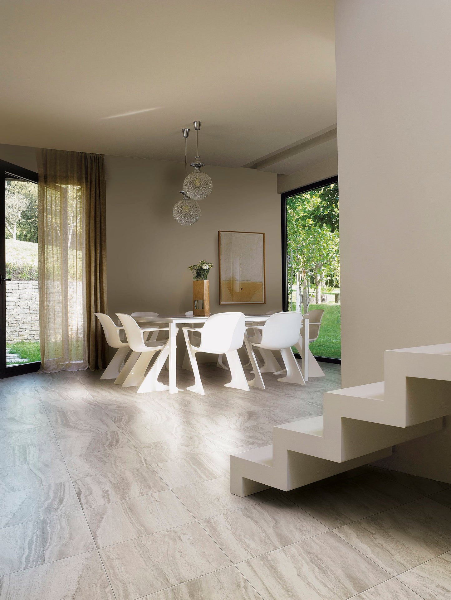 This is a room scene of a dining room with widen modern chairs and matching table. The floor is rocca di roma in the color silver