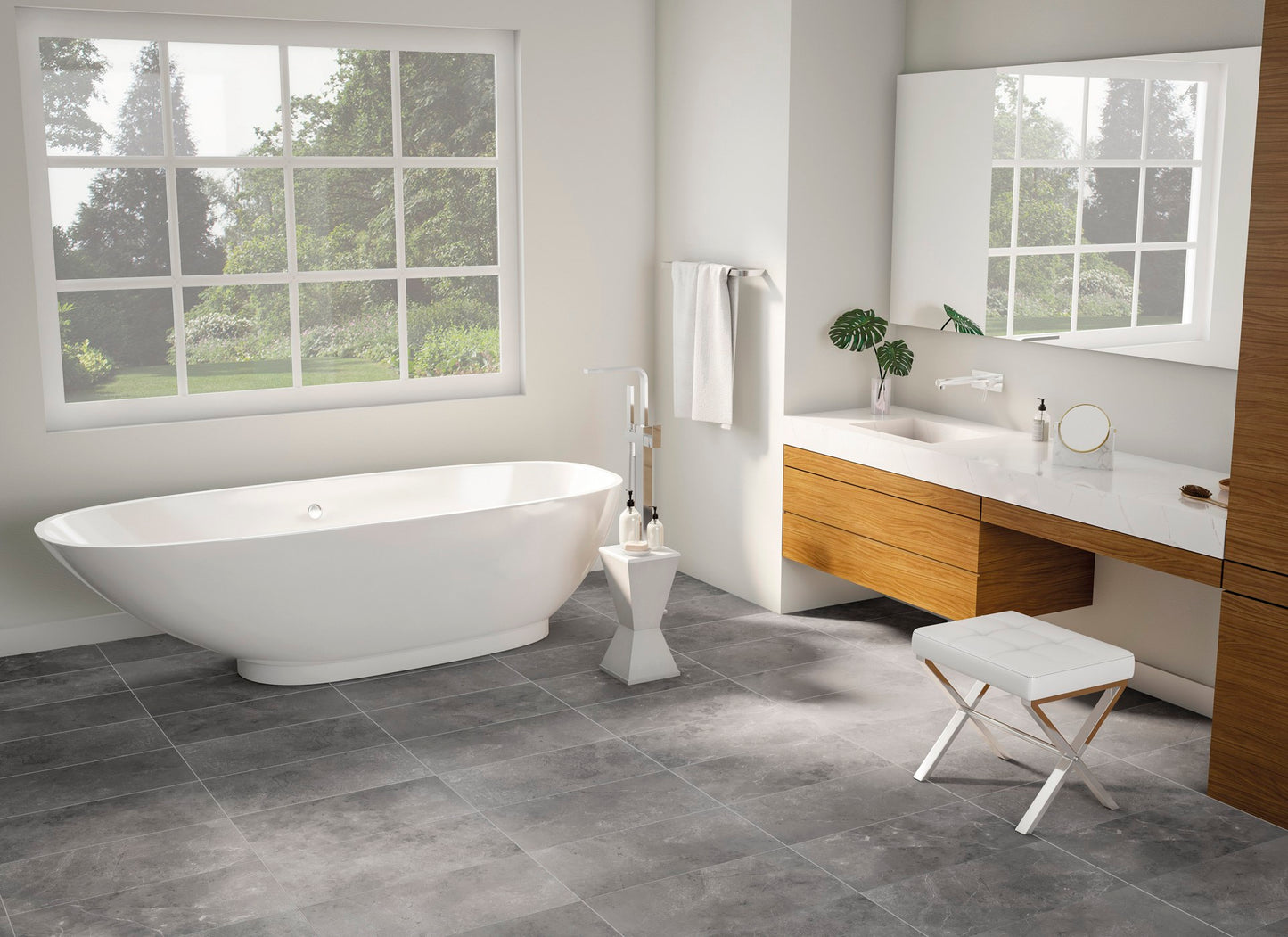 This is a bathroom room scene with a single white tub with natural wood furniture. The floor tile is st croix in the color ash