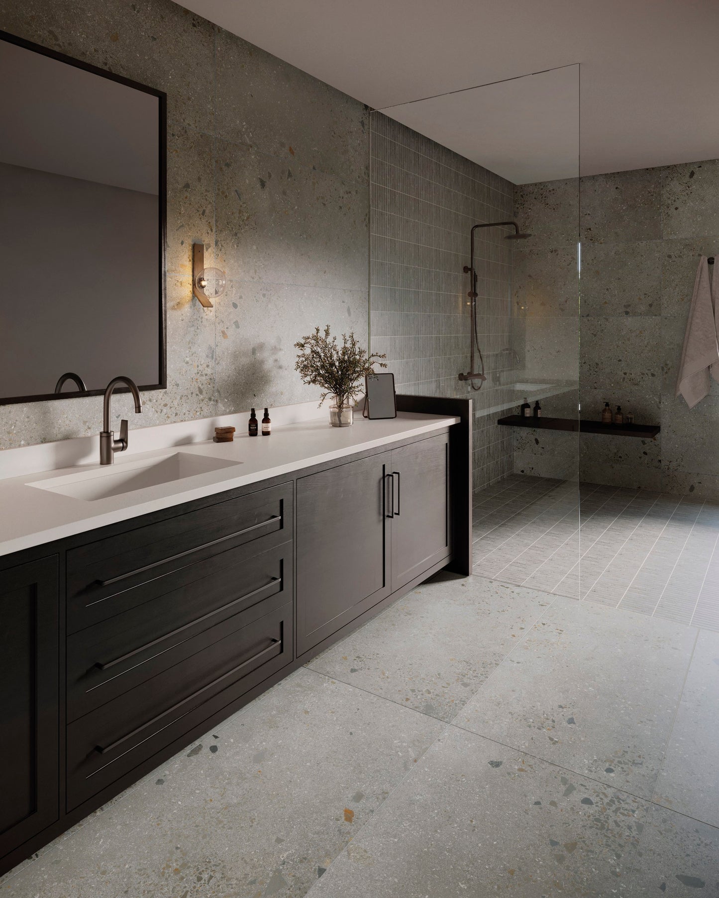 This is a room scene of a bathroom using the tile lab in the color ash. It has a walk in shower with dark furniture