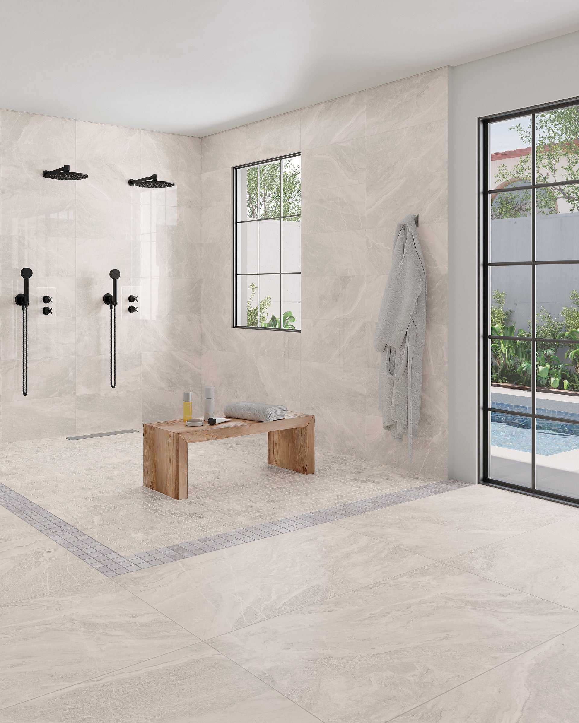 This is a room scene of a zero entry shower with double shower heads. There is a wooden bench inside the shower. The tile floor is storm in the color white.