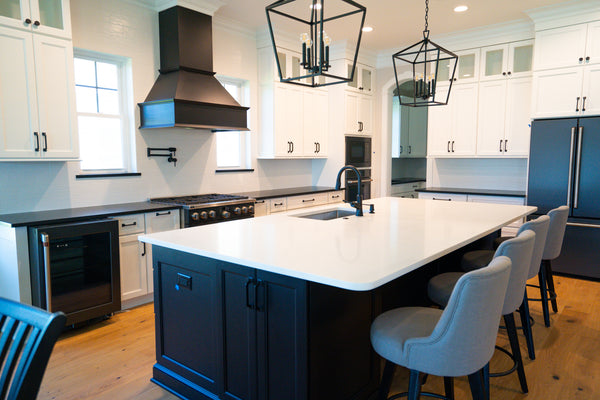 a white subway tile in a kitchen with black hardware