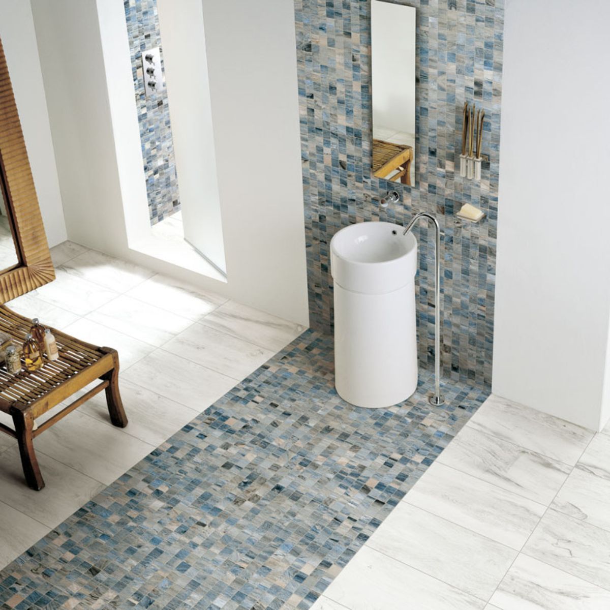 bathroom scene with mosaic waterfall. There are variated blue color tiles