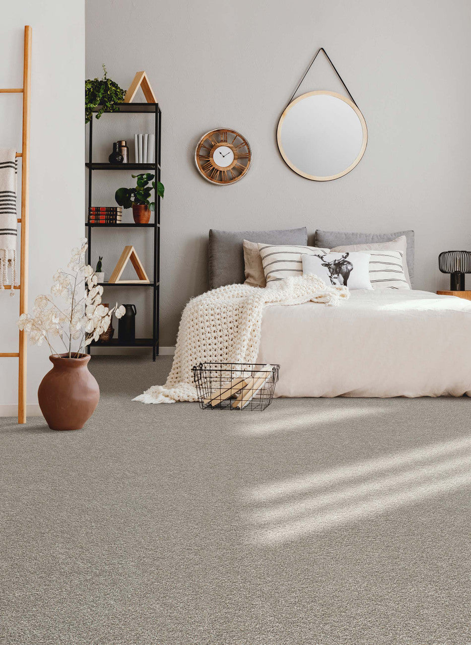 Autumn glow carpet by dreamweaver in a bedroom setting with neutral color pallet and a blanket ladder and black bookcase