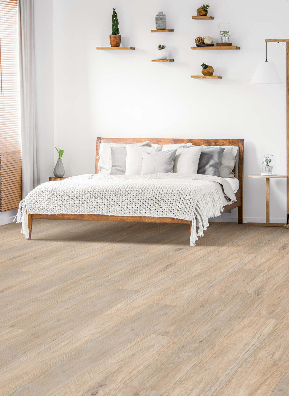 This is a room scene of a bedroom with natural wood floating shelves with decor and a wood bedframe. This flooring is riverwood in the color carpoathian