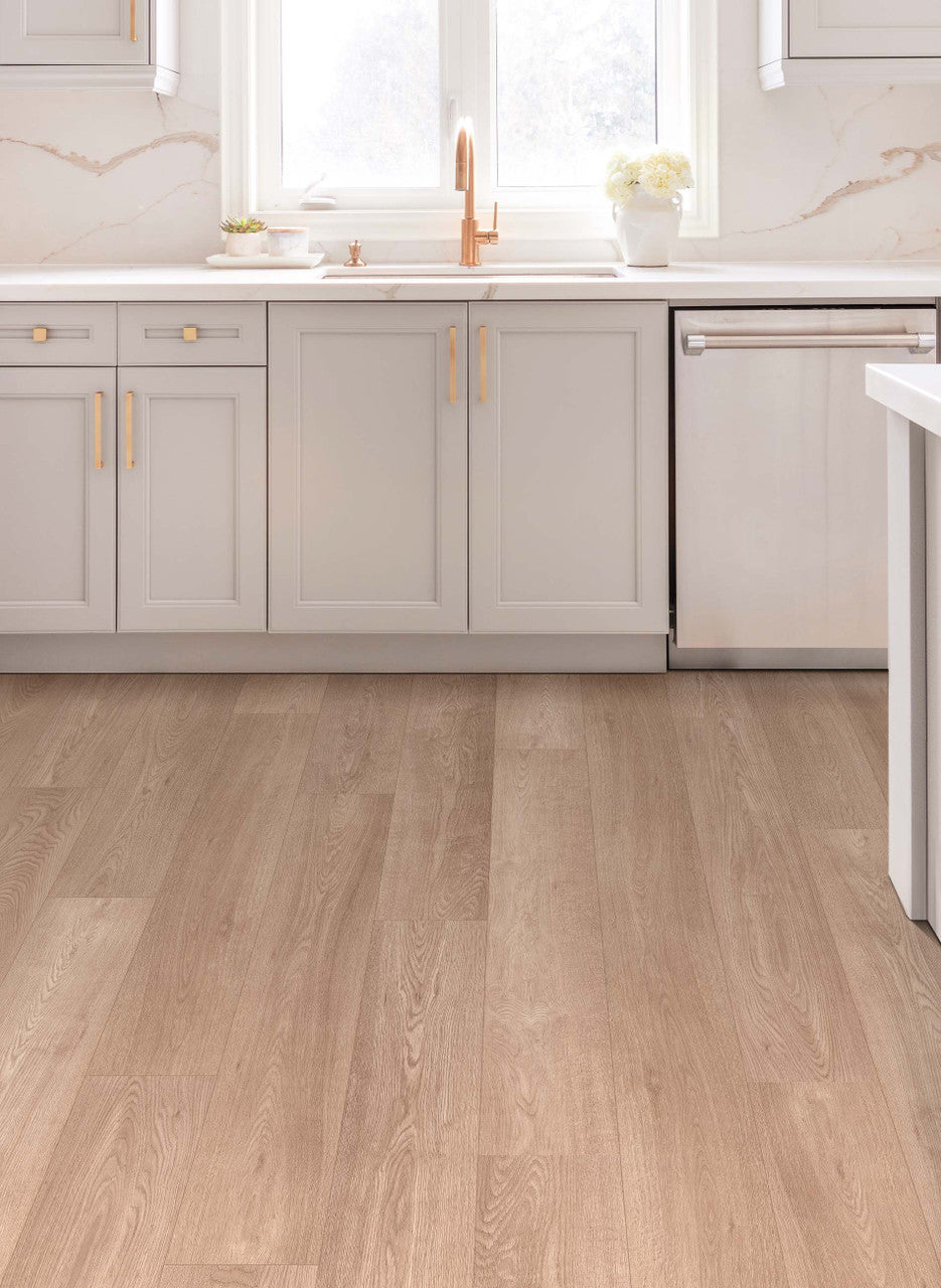 This is a room scene of a kitchen with marble backsplash and light grey cabinets. The floor is riverwood in the color sandalwood