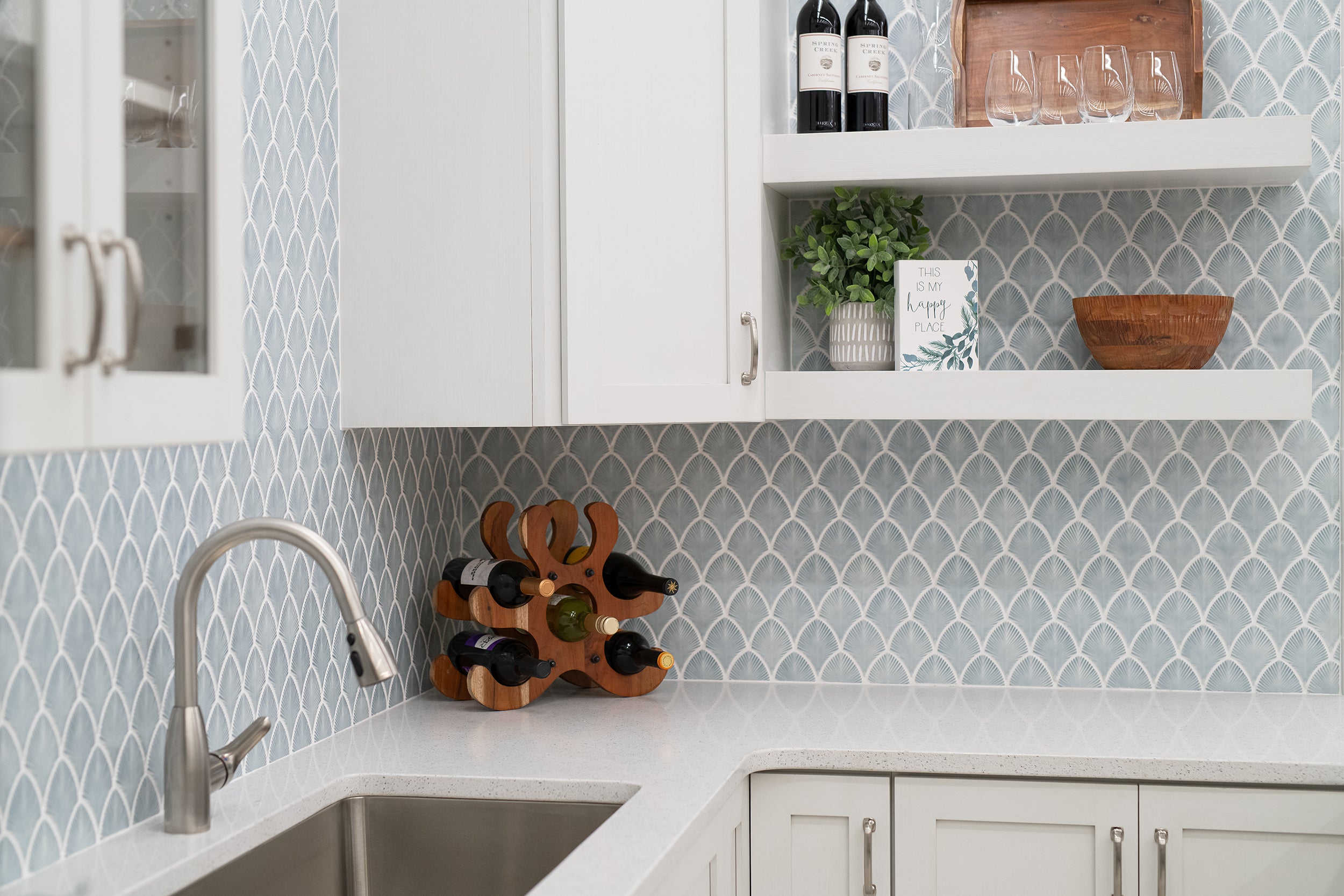 A kitchen image with a blue shell like backsplash