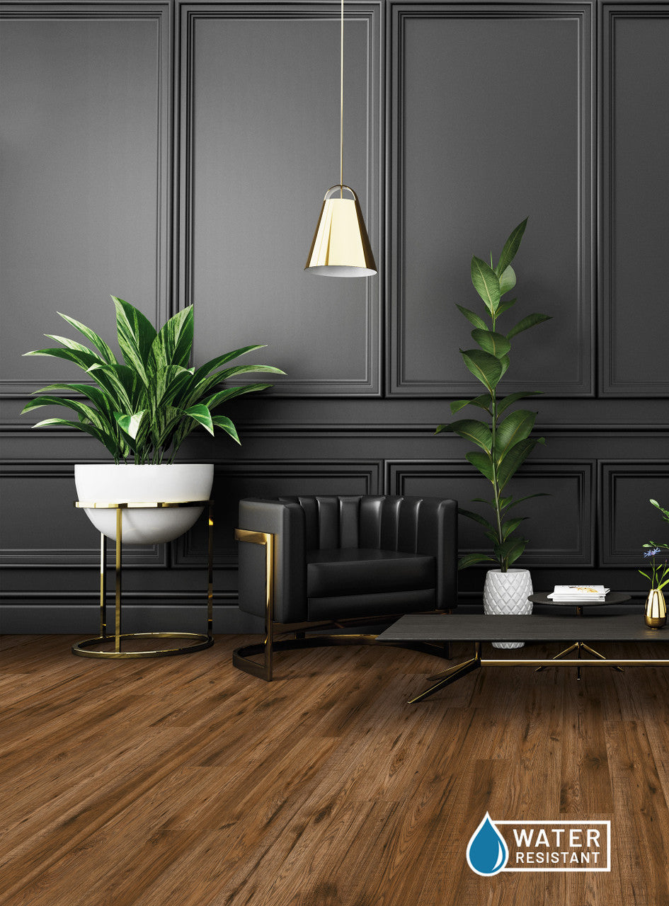 This is a room scene of the laminate flooring woodlux. There is black furniture paired with gold accents