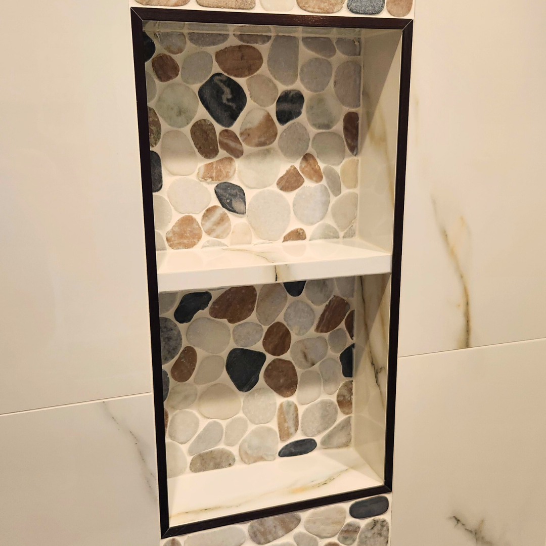 Niche with pebble tile design on a wall
