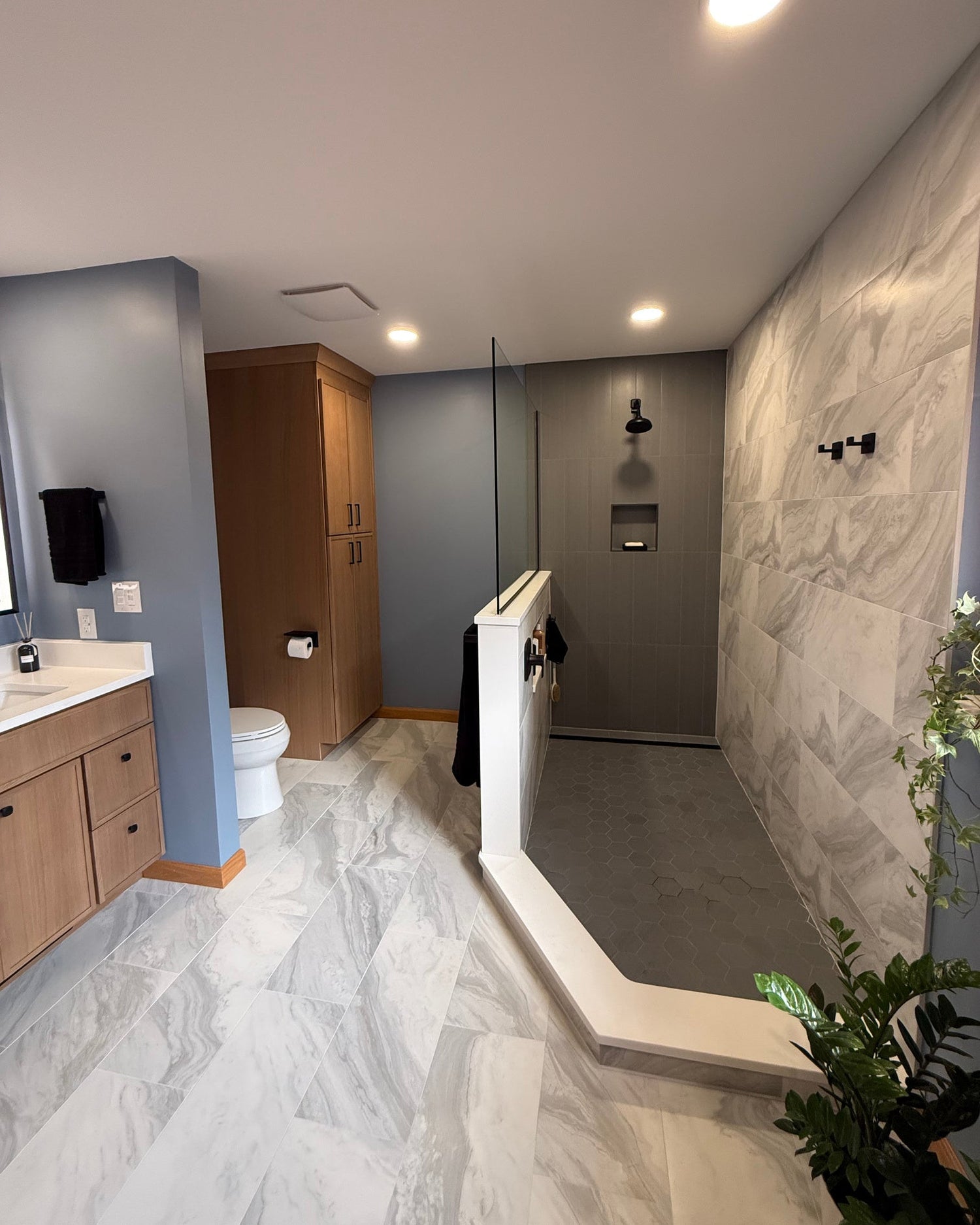 Modern bathroom with shower, vanity, and toilet