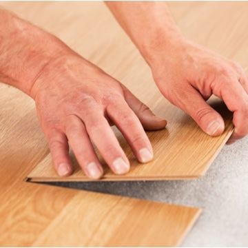 hands laying down lvp flooring