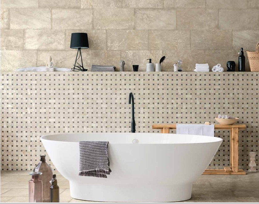 This is a room scene of a bathroom with a white tub and many decor items. This is the tile marmi imperial in octavia