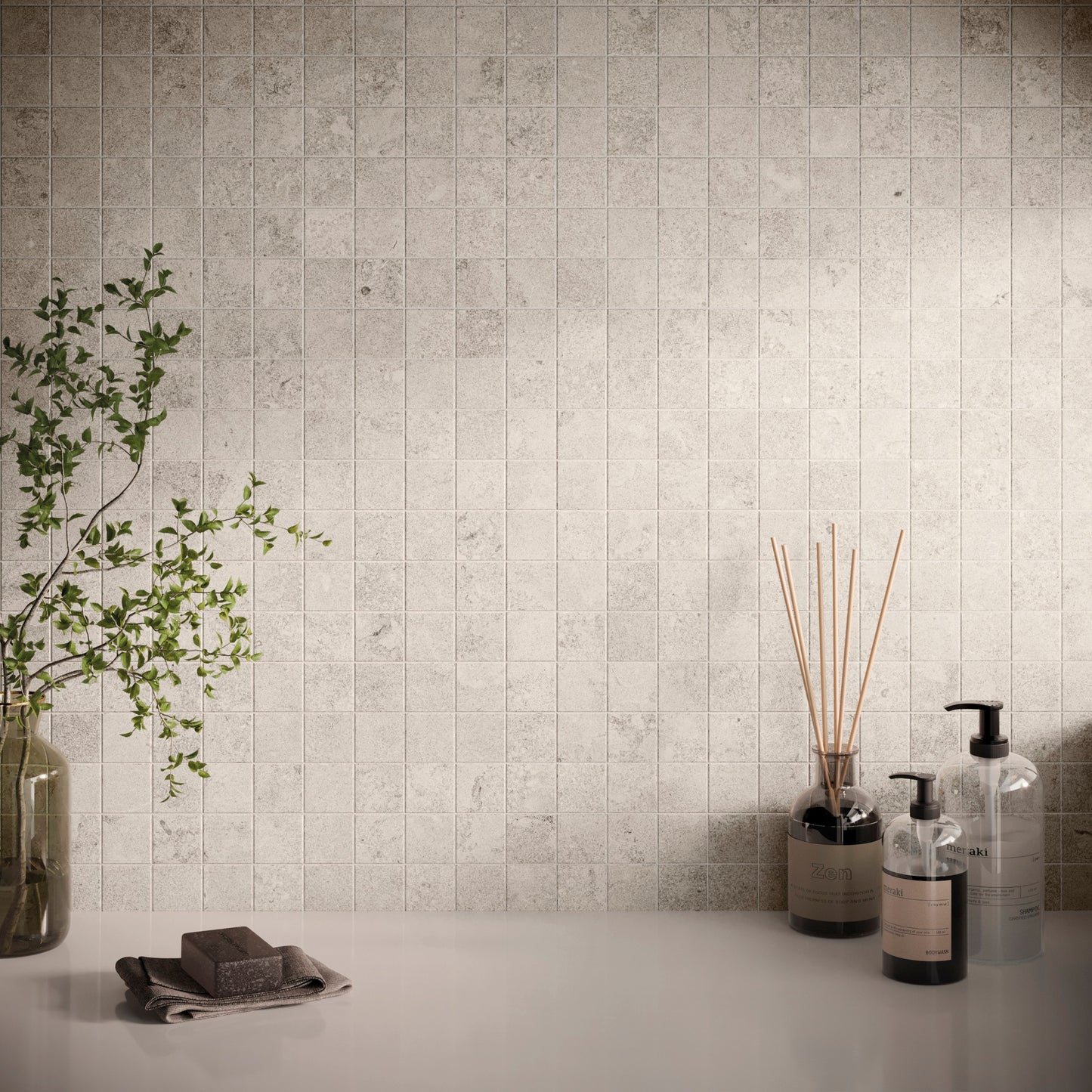 This is a display scnene of the backsplash norian in the color ivory. There are soap dispenser in the right corner and a plant in the left corner