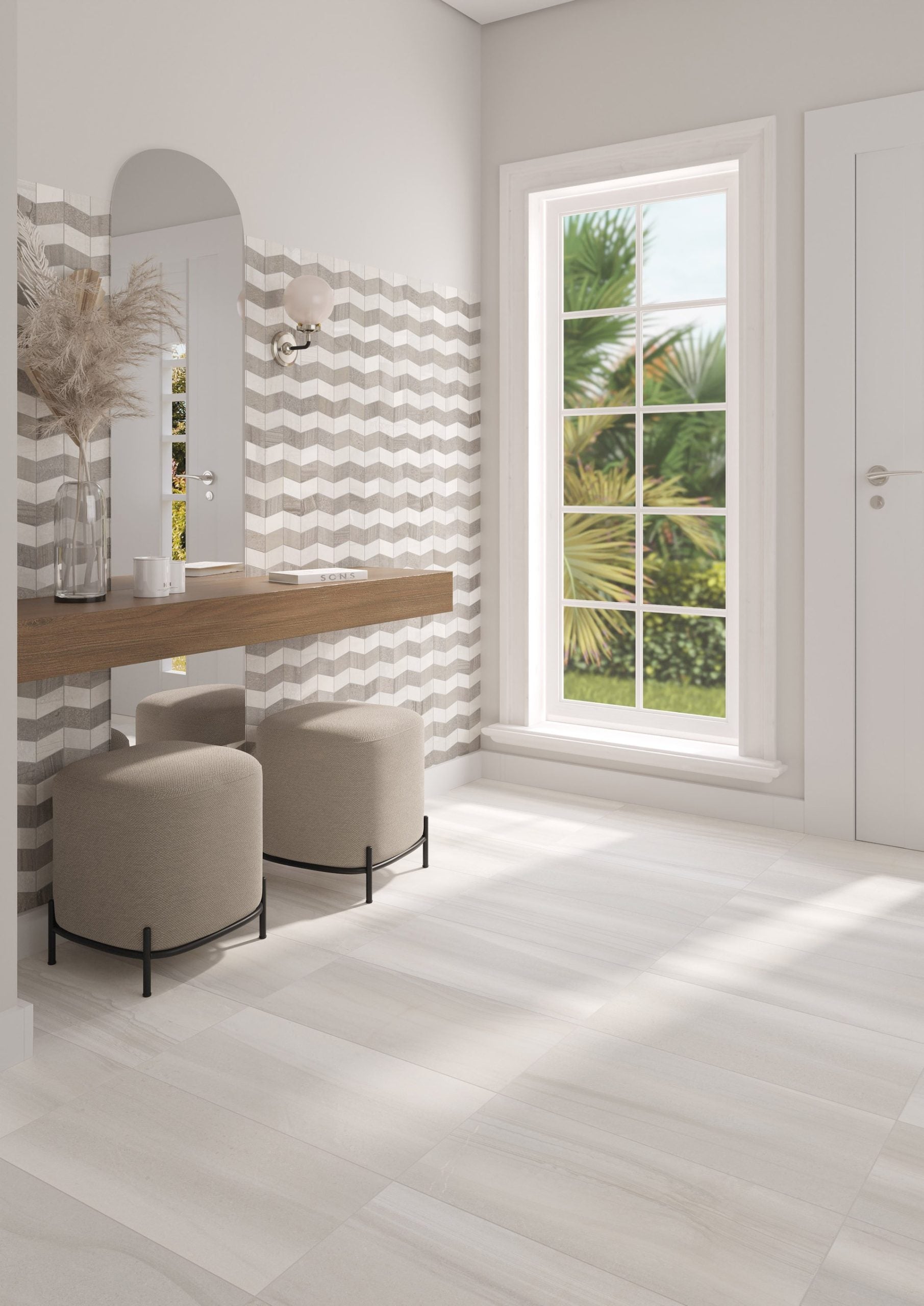 This is a room scene of an entry way with the floor being sandwaves tile in the color marshmellow. The is an arched mirror with a chevron pattern accent wall