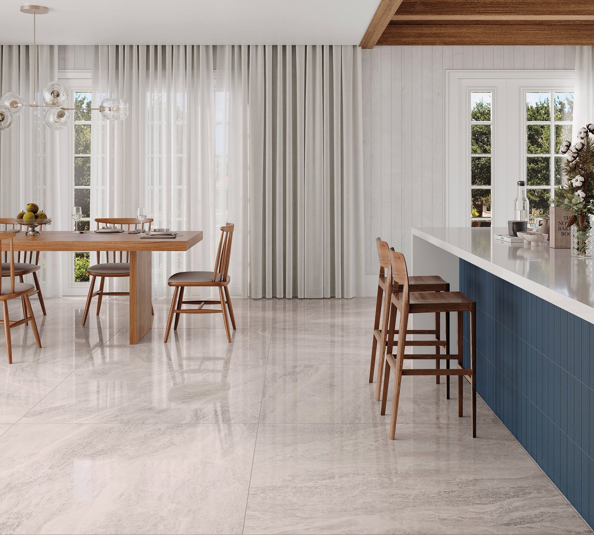 This is a room scene of a kitchen and dining room with wood furniture and blue accent walls. The tile floor is polished storm in white.